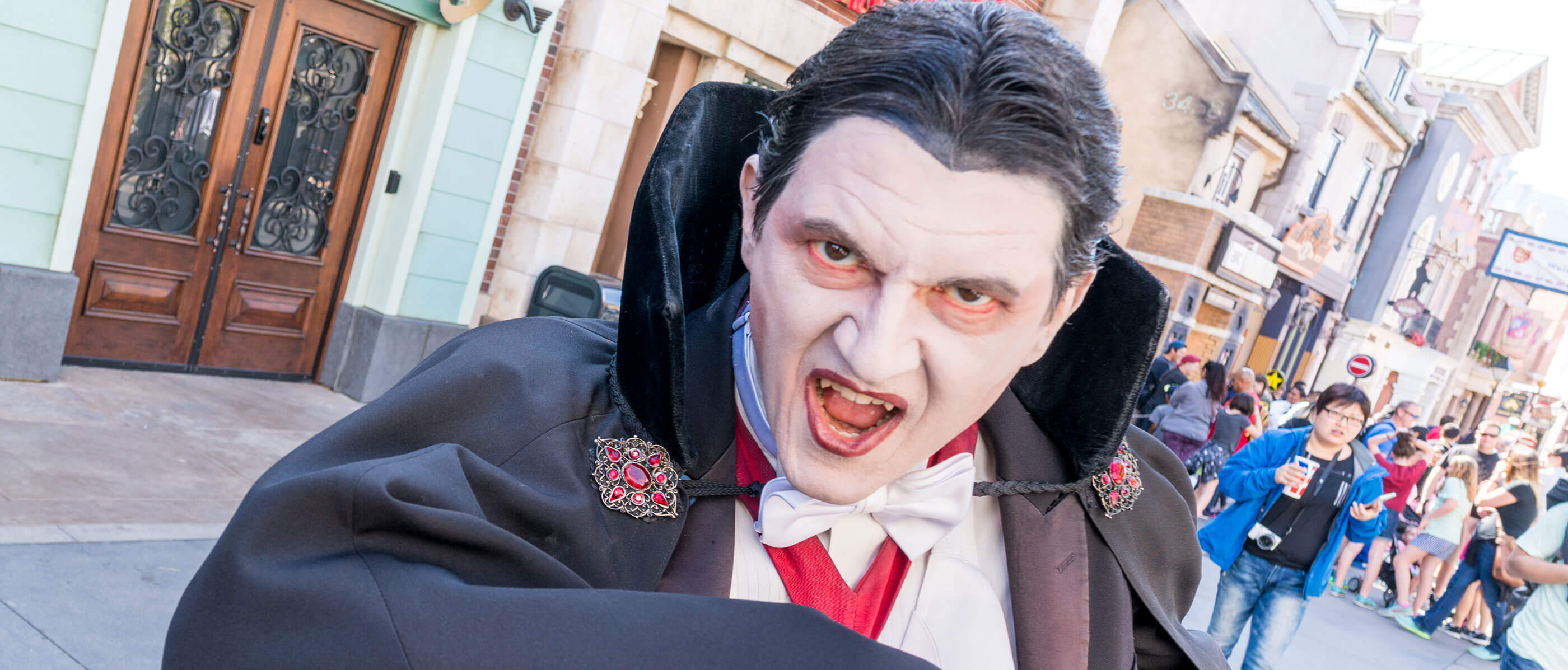 An actor dressed as Dracula poses for the camera.