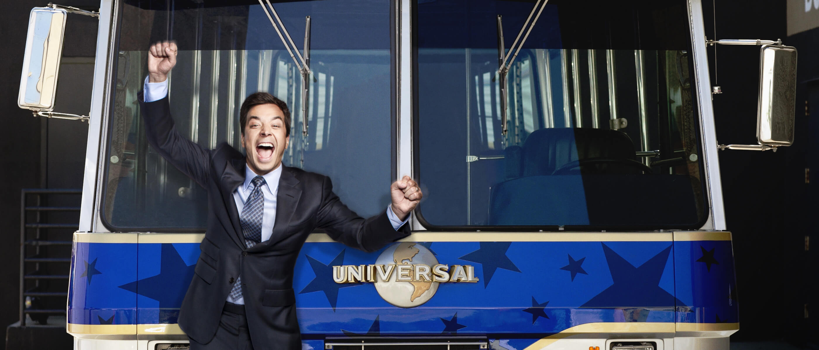 Jimmy Fallon in front of a Universal tour bus.