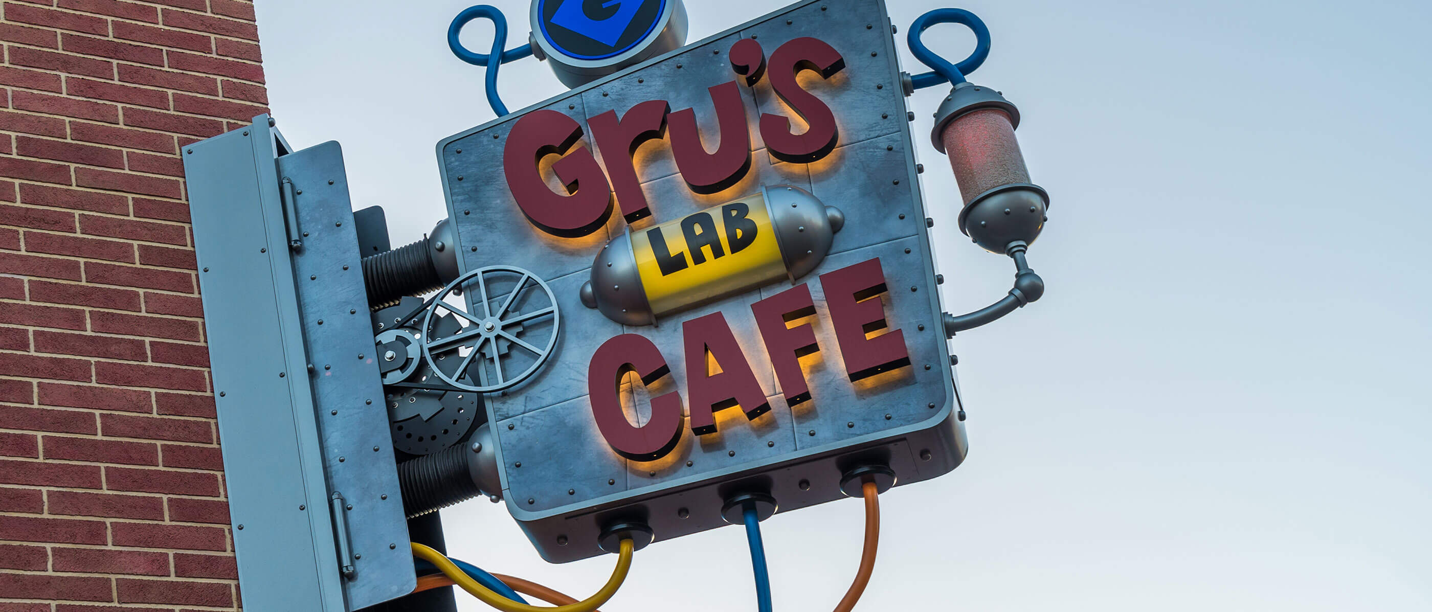 Gru's Lab Cafe sign on a brick building.
