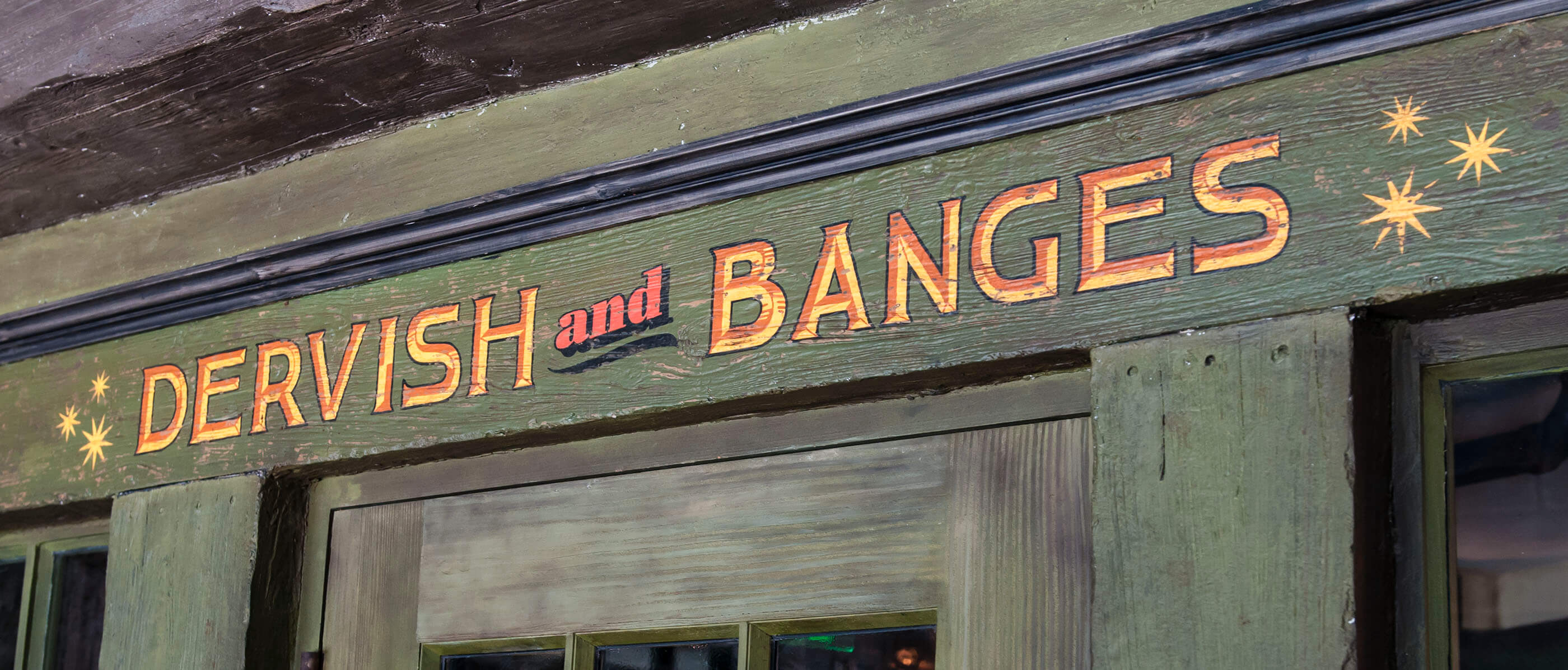 Dervish and Bangels sign above a green door.