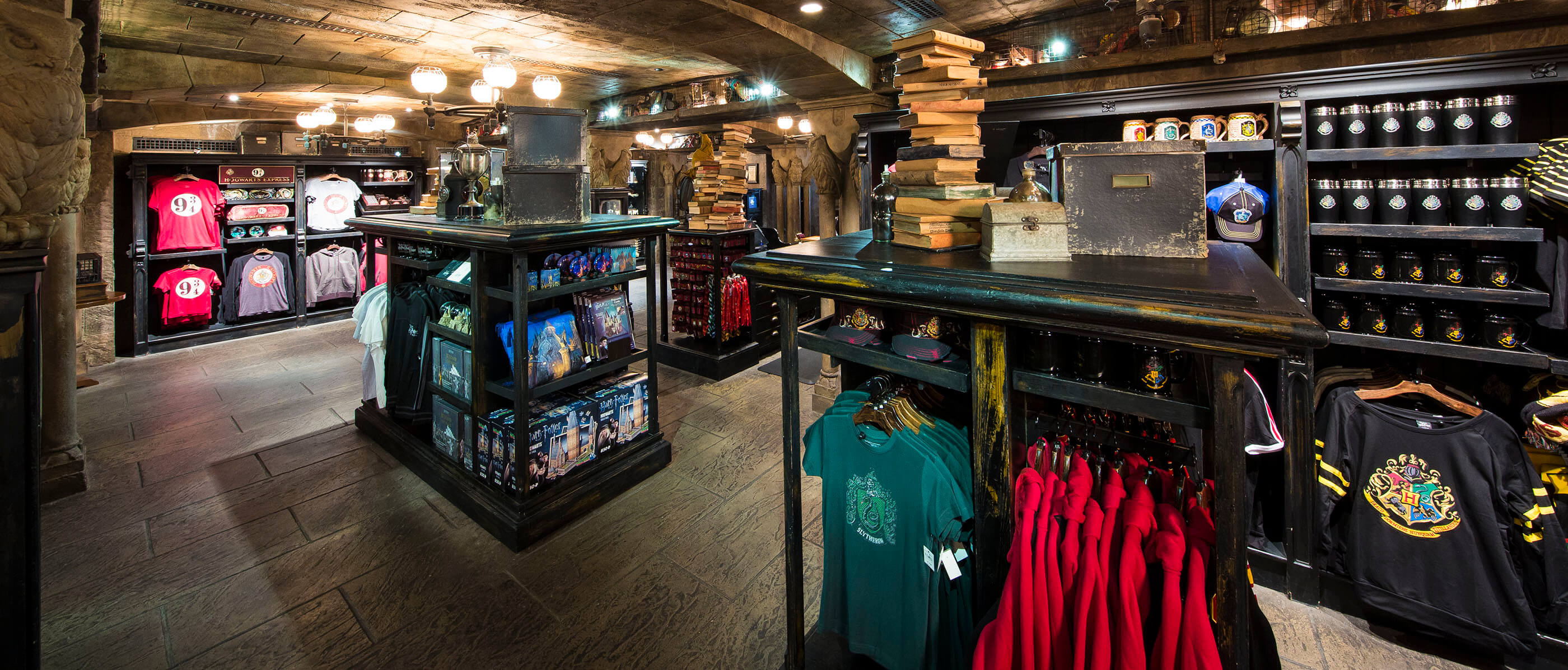 Harry Potter clothing store with stone walls and black shelves.