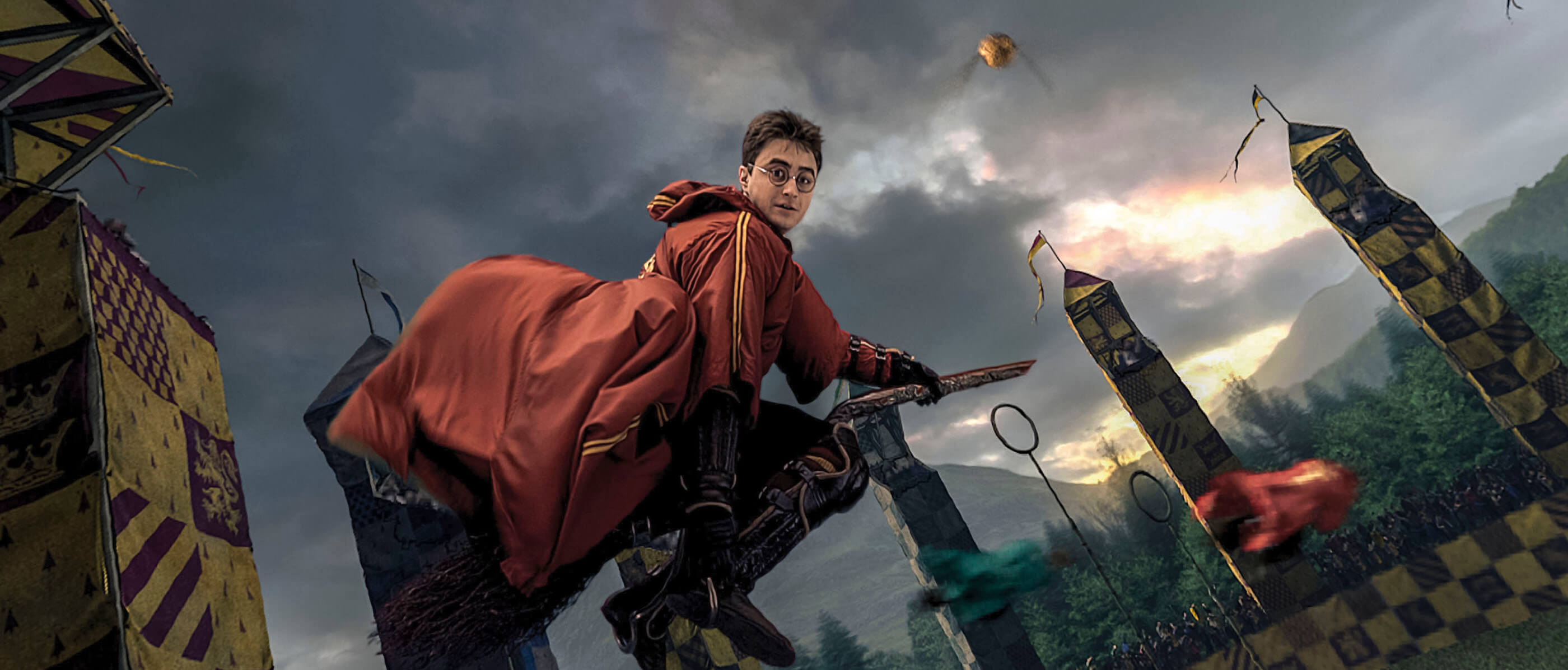 Harry Potter on a broom in a Quidditch match on a cloudy evening.