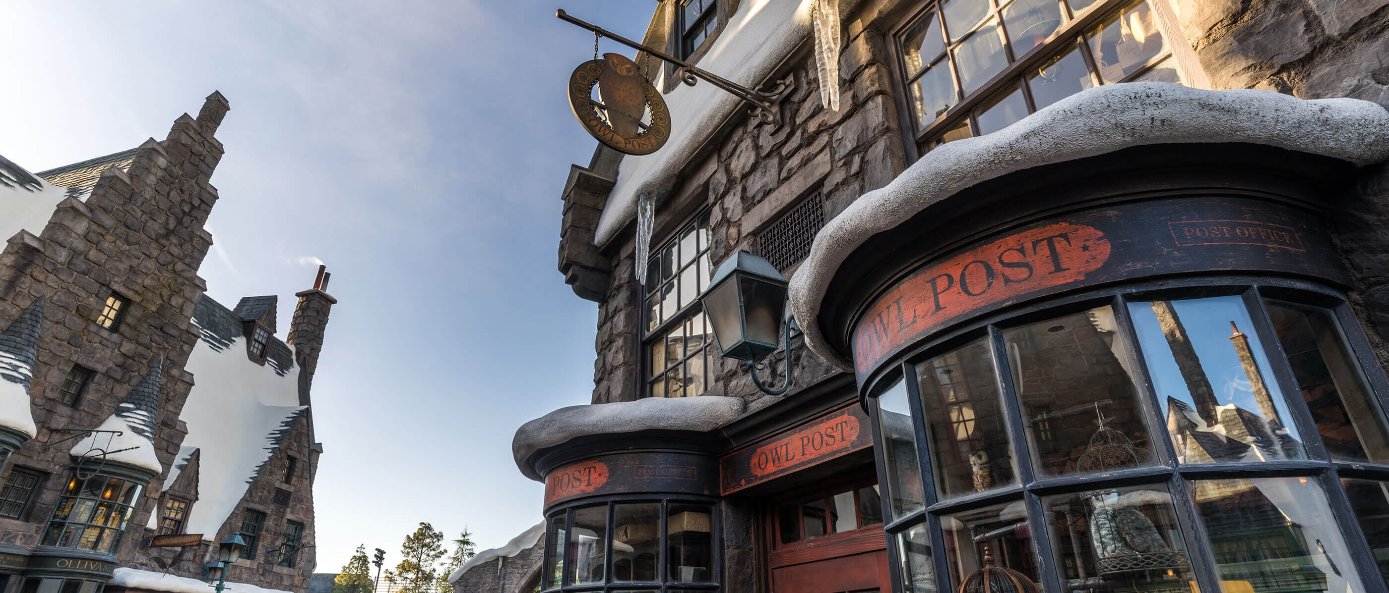 The outside of the Owl Post which is black with stone and a red label.