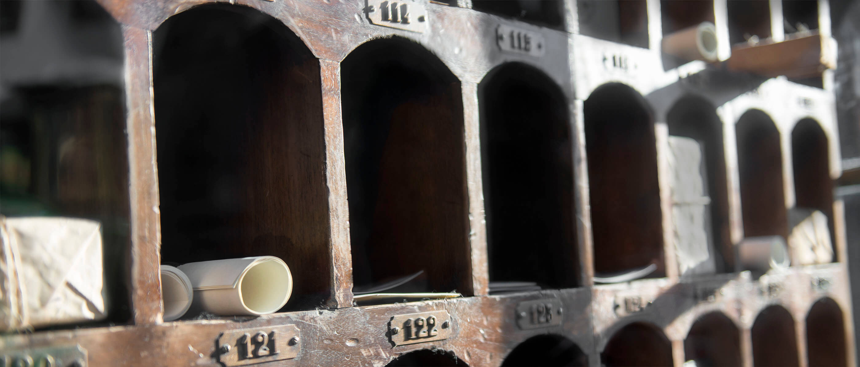 Old fashion mailboxes with rolls of parchment.
