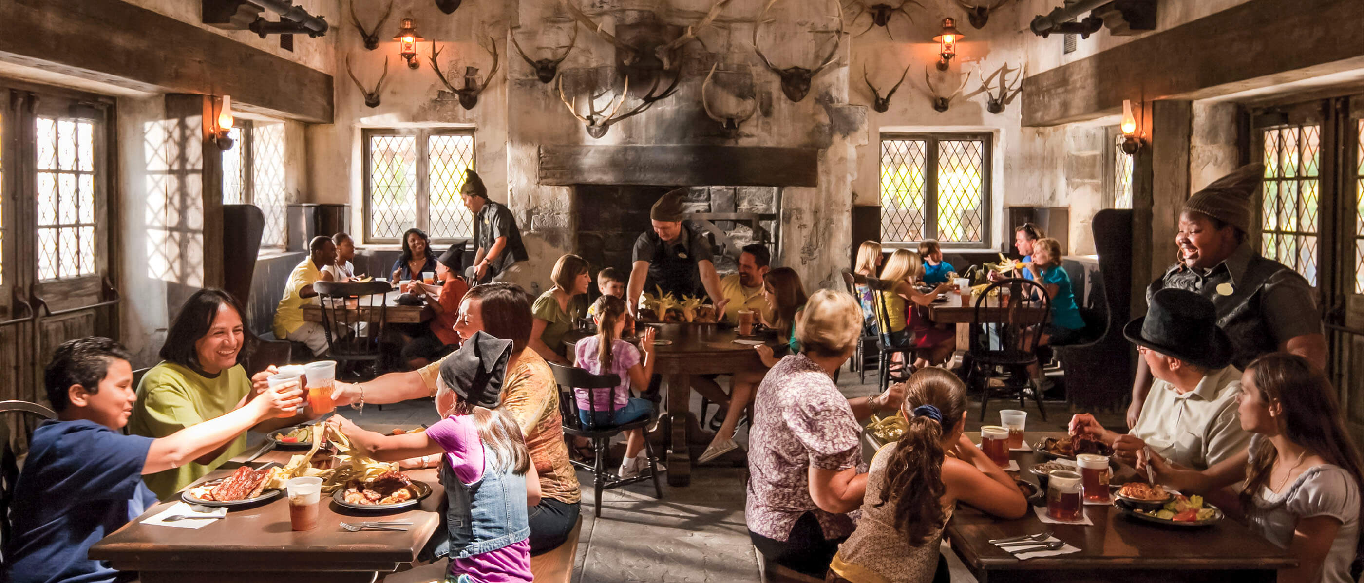 The restaurant Three Broomsticks with many families eating and drinking.