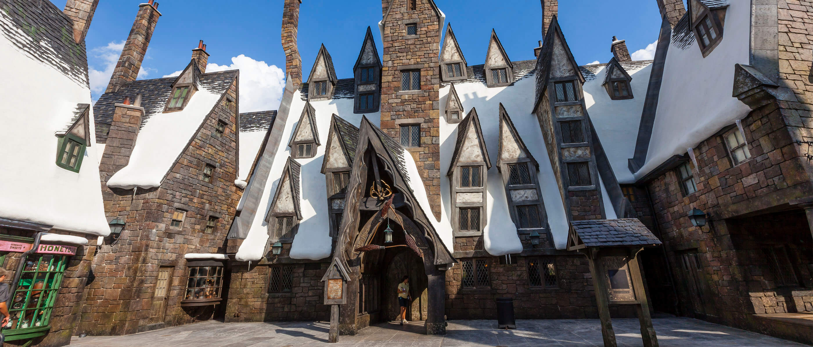 An exterior shot of The Three Broomsticks in The Wizarding World of Harry Potter.