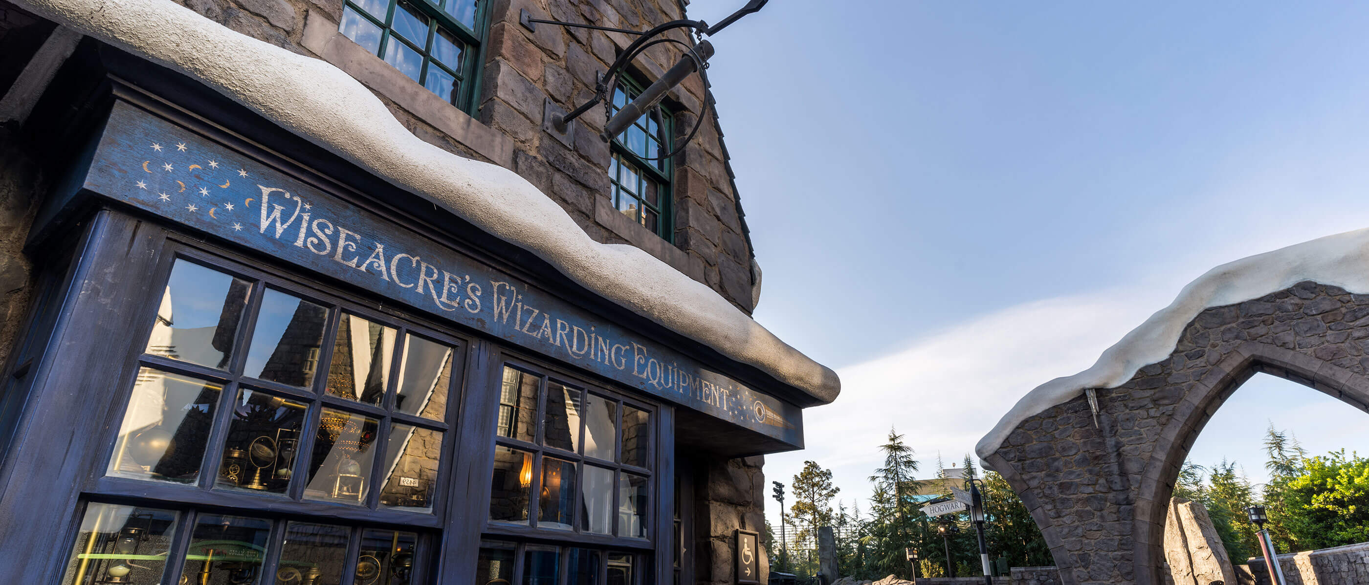 Brick building with fake snow on top of the window with the logo Wiseacre's Wizarding Equipment.