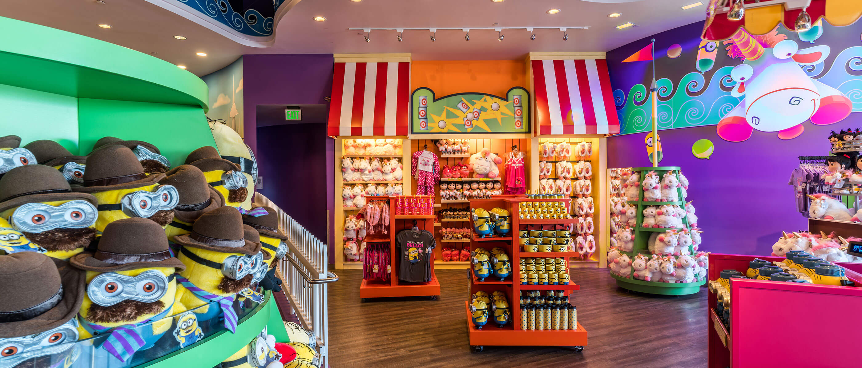 A retail store with minion and unicorn product and purple walls.