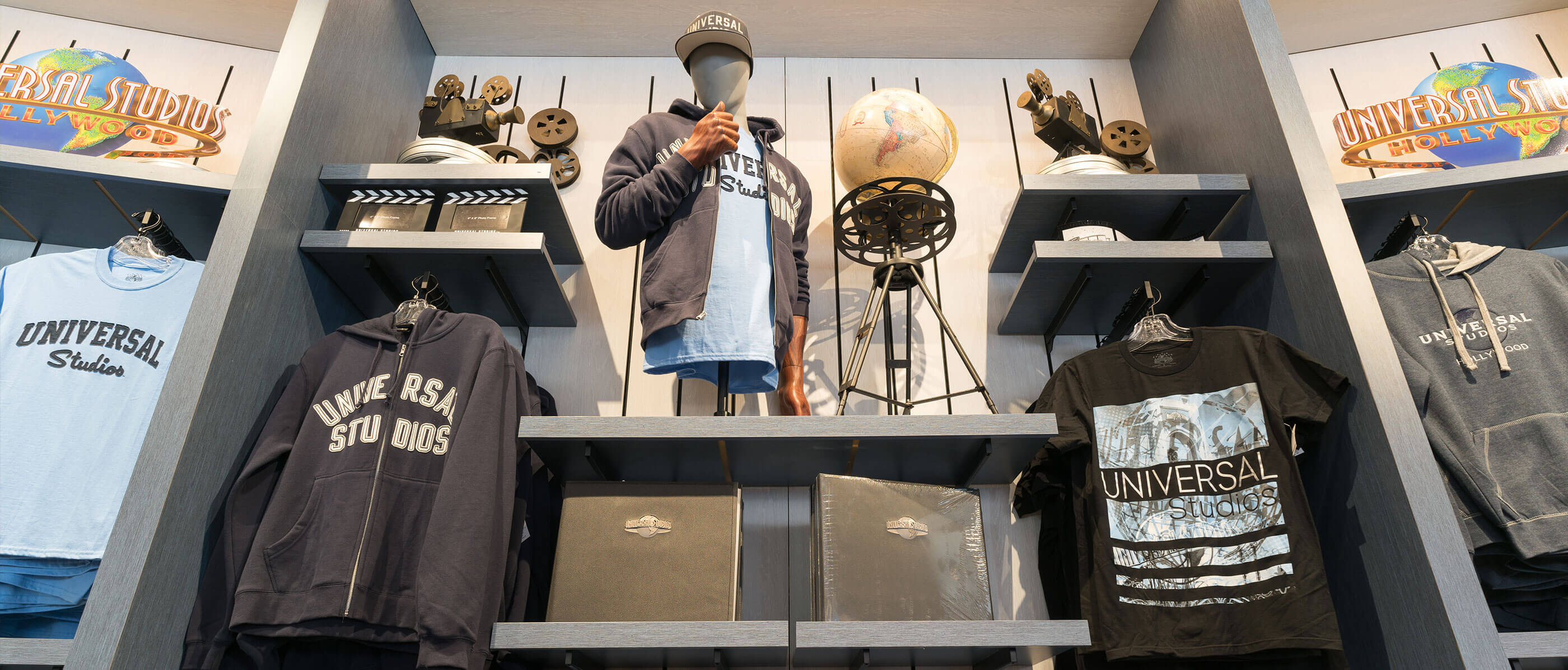 Wall inside a store, full of Universal Studios merchandise.