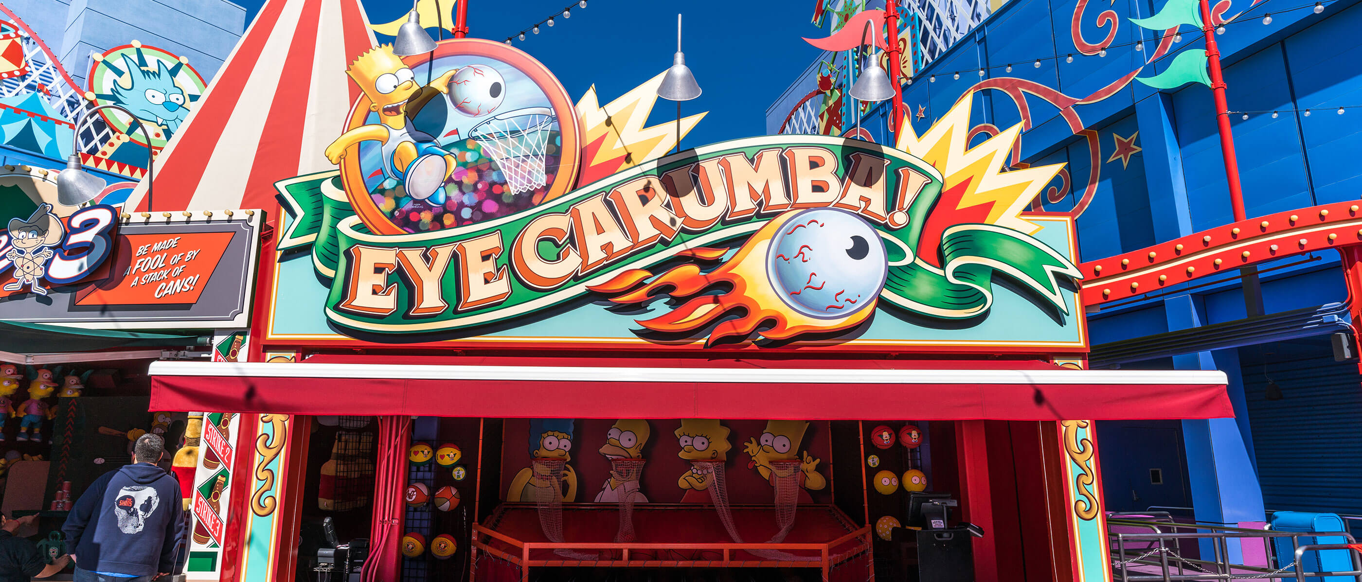 Eye Caramba sign with an eye ball on fire and the Simpson characters below.