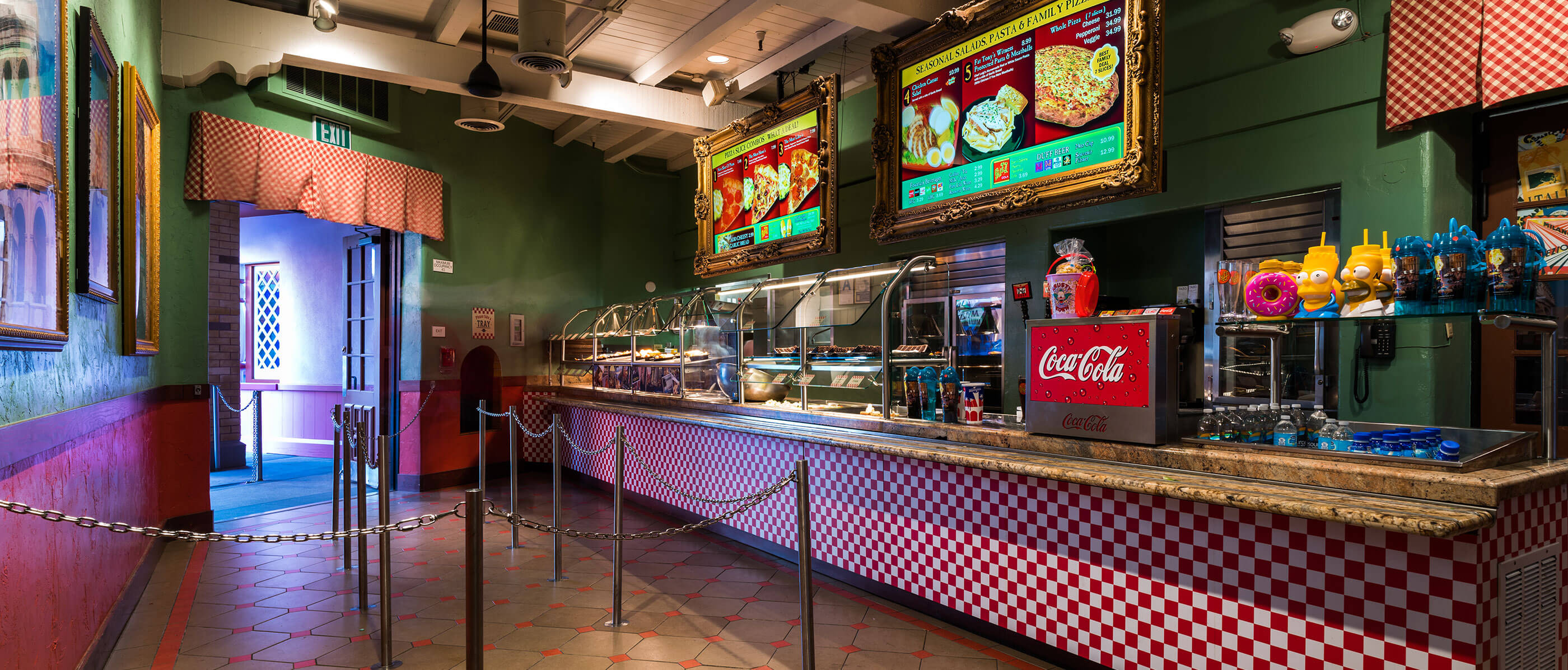 The inside of a fast food restaurant with a red and brown floor.
