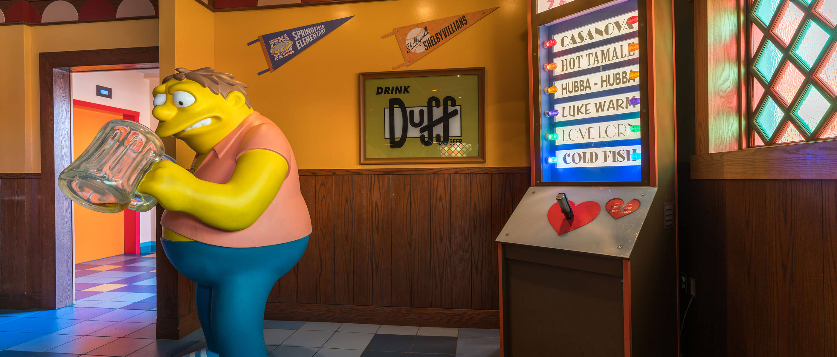 A Simpson's character looking into a beer mug at Moe's.