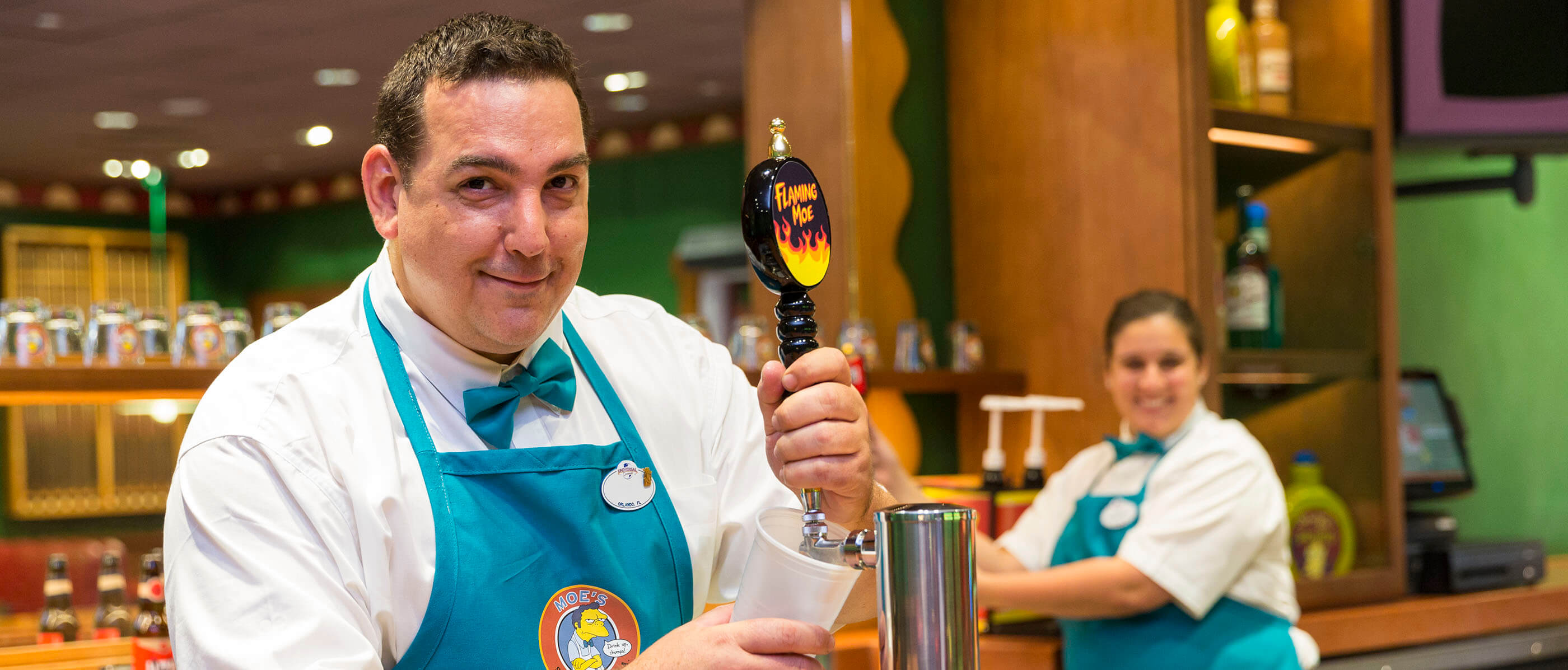 A bartender pouring a beer at Moe's Tavern.