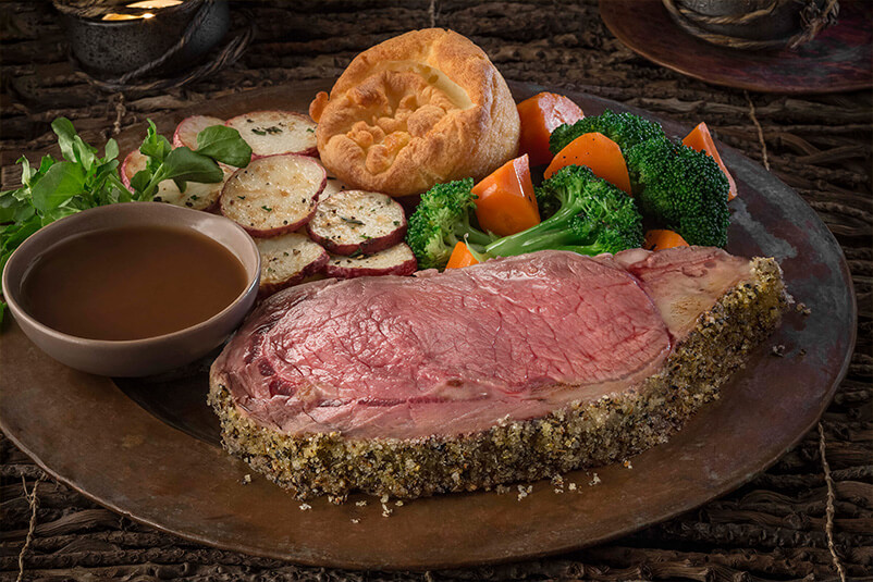A plate of steak, potatoes, and veggies.