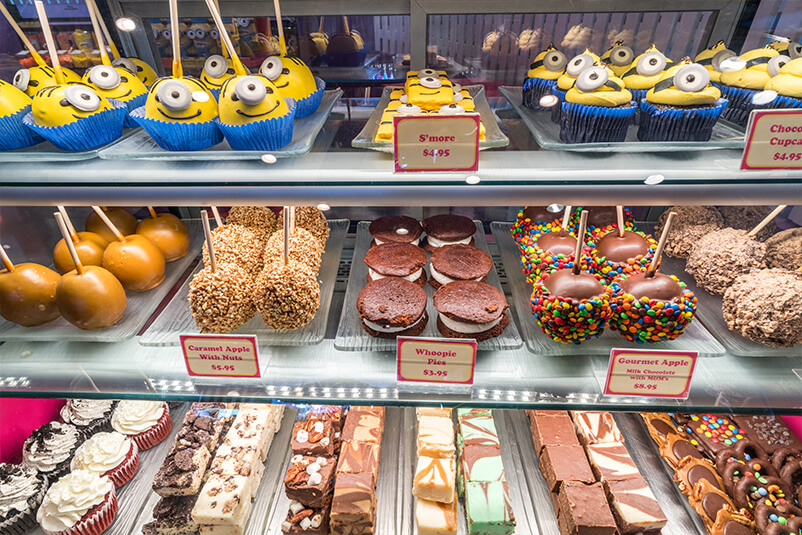 Shelves with treats on it under a light.