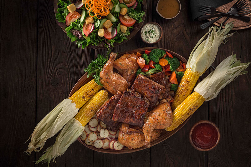 Three Broomsticks feast with corn, meals, and vegetables.
