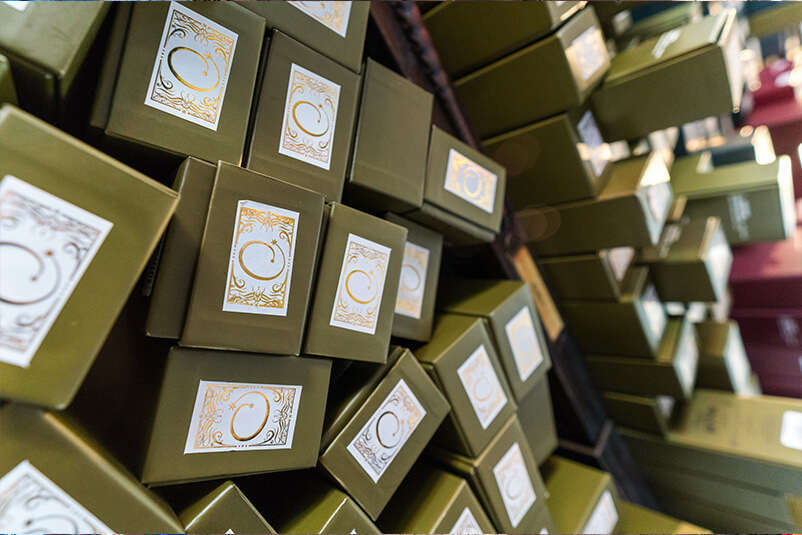 Ollivanders black wand boxes with a white and gold sticker.