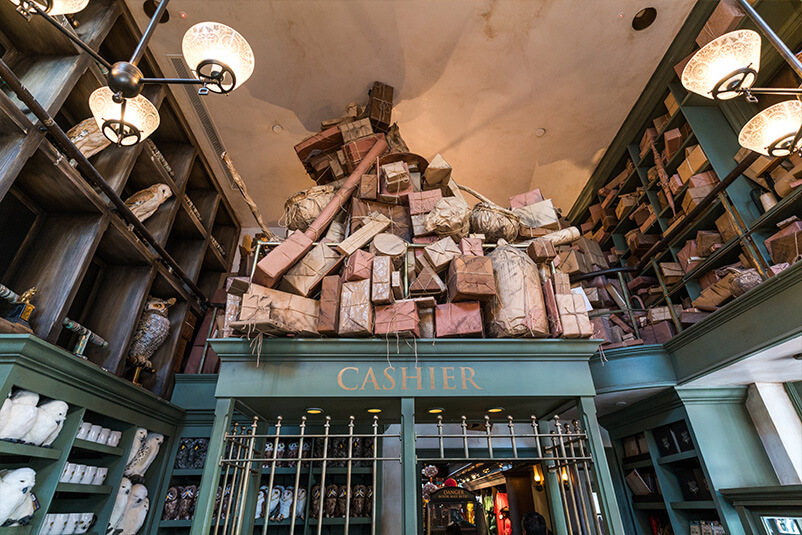 Multiple wrapped objects on top of a green shelf with the word 