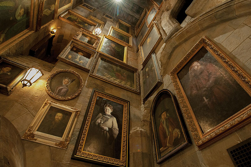 Walls with multiple portraits on them.