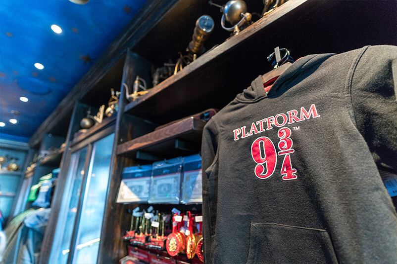 Shelves of merchandise and a grey sweater with Platform 9 3/4 on the front of it.