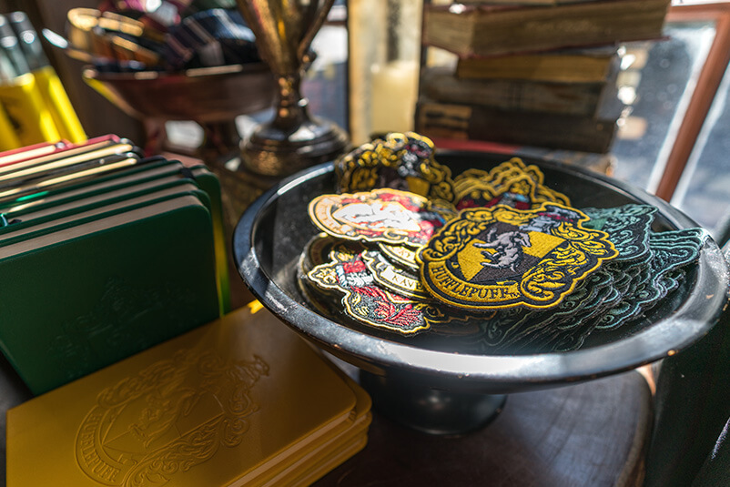 A bowl holding Harry Potter houses crests.