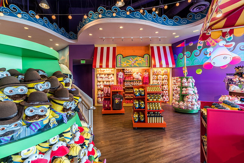 Retail store with minion and unicorn product and purple walls.