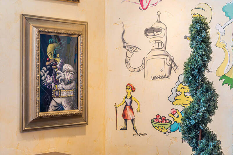 A wall with drawings of characters from the Simpsons.