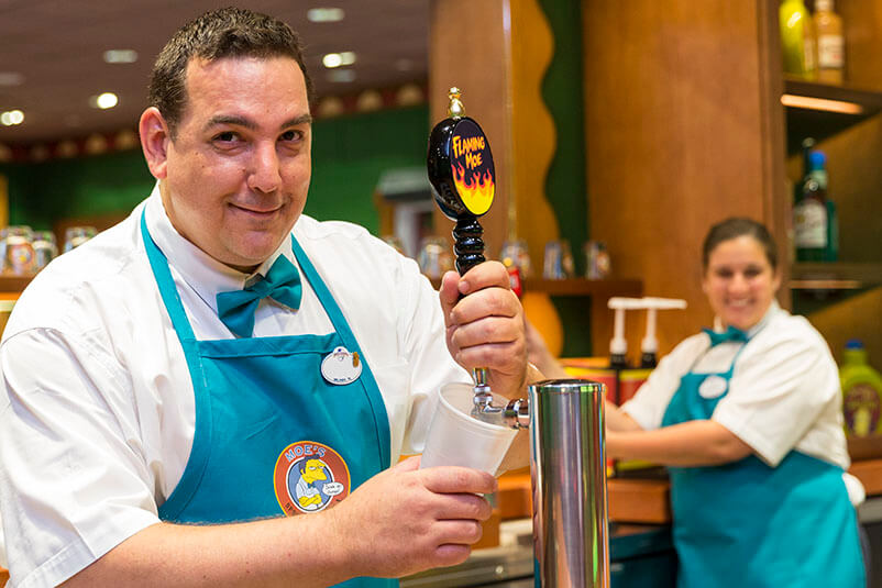 A bartender pouring a beer at Moe's Tavern.