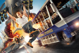 Fast and the Furious poster with Vin Diesel holding onto a plan and a Universal Studio tour bus beside it.