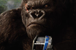 King Kong up close squeezing a bus.