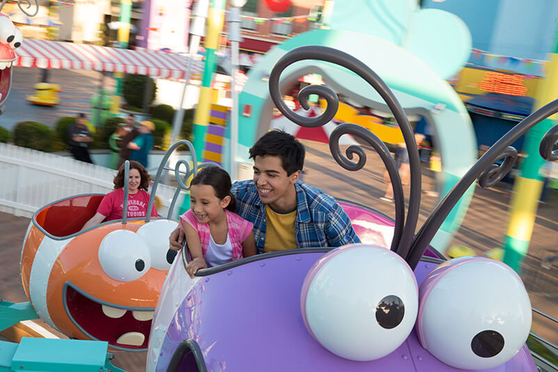 A young boy and girl on a Super Silly Fun Land ride.