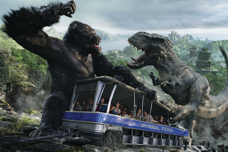 Studio tour of the King Kong set with King Kong fighting in the background.