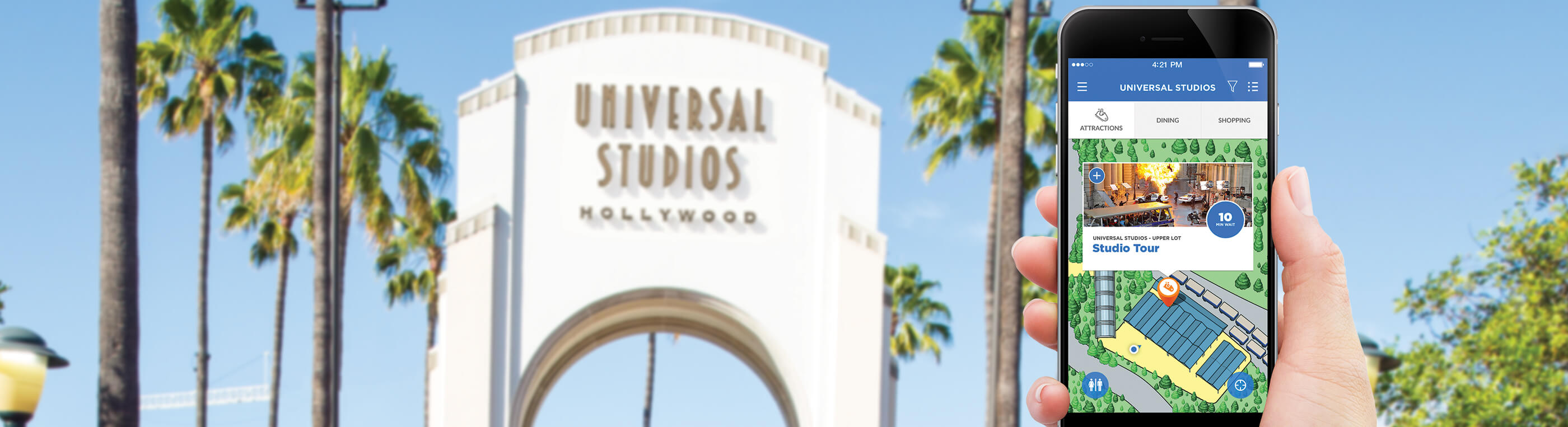 Hand holding phone with Universal app in front of arch