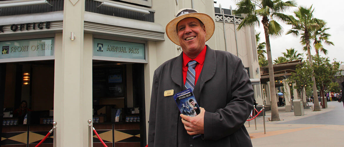 A smiling employee holding Park maps