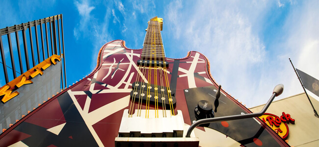 A photo from the base of a large guitar outside of the Hard Rock Café.