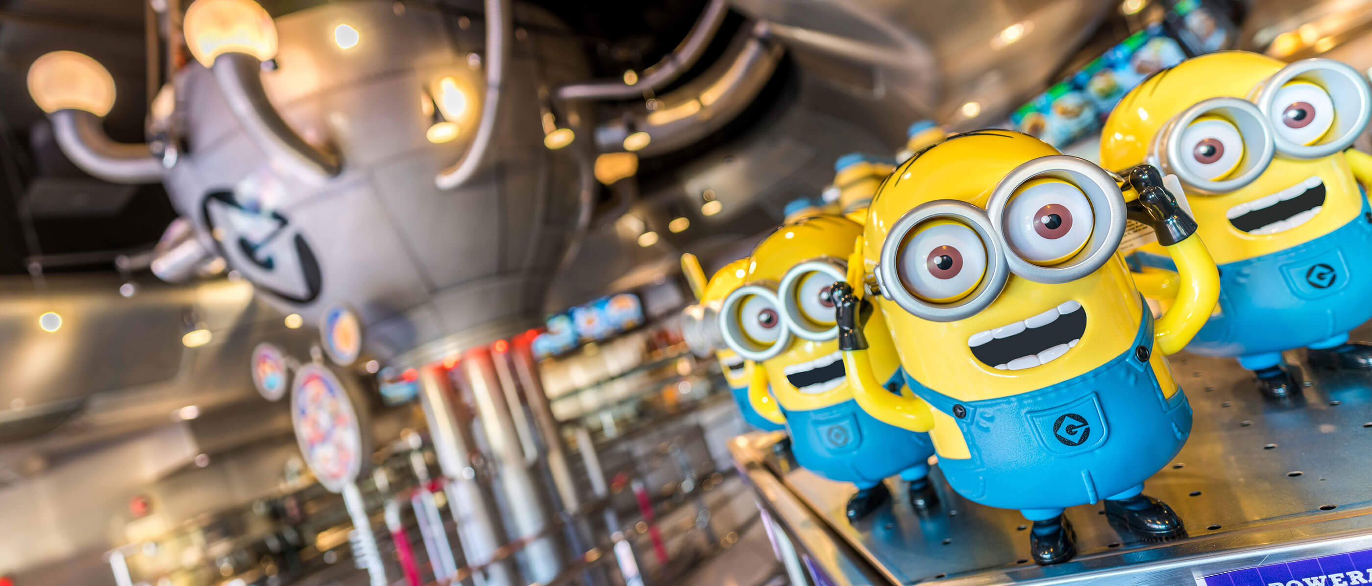 Minion figurines and a metal ball behind.