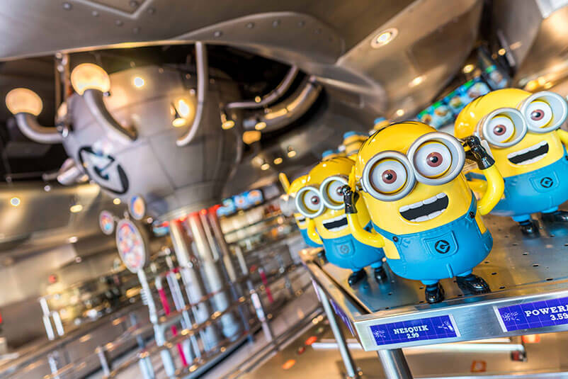 Minion figurines and a metal ball behind.