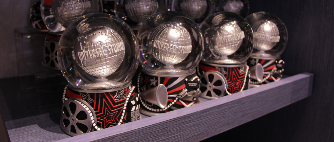 Universal Studios globe fountain snow globes on a shelf