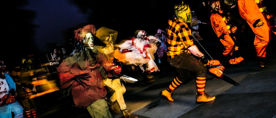 Character running with chainsaws during Halloween Horror Nights