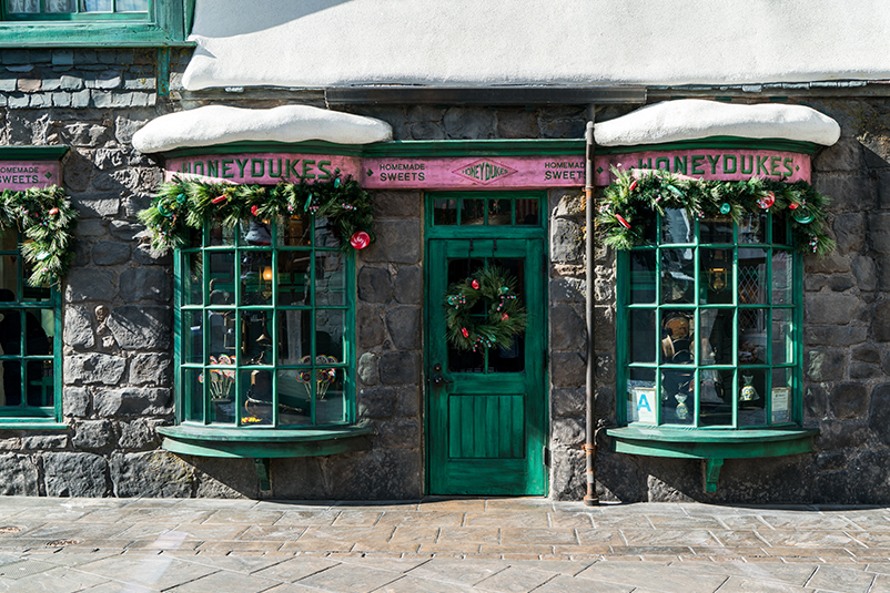 Outside of Honeydukes decorated with Holiday decorations
