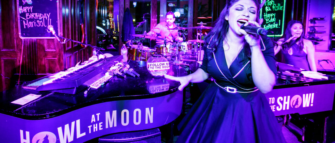 Female singing at a piano bar