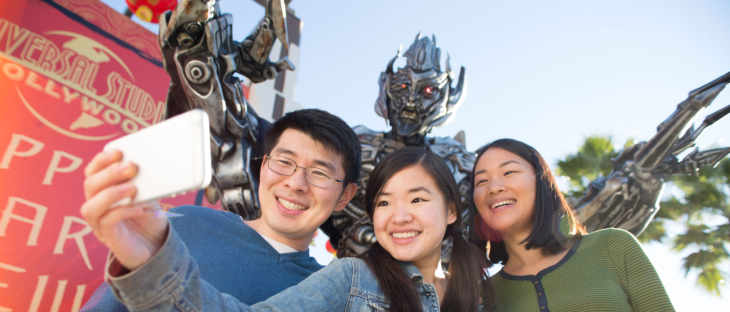 Guests taking a selfie in front of Megatron