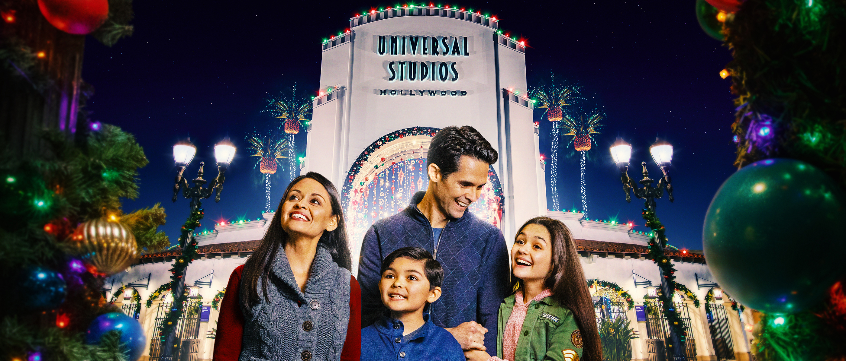 A family in front of the USH Arch